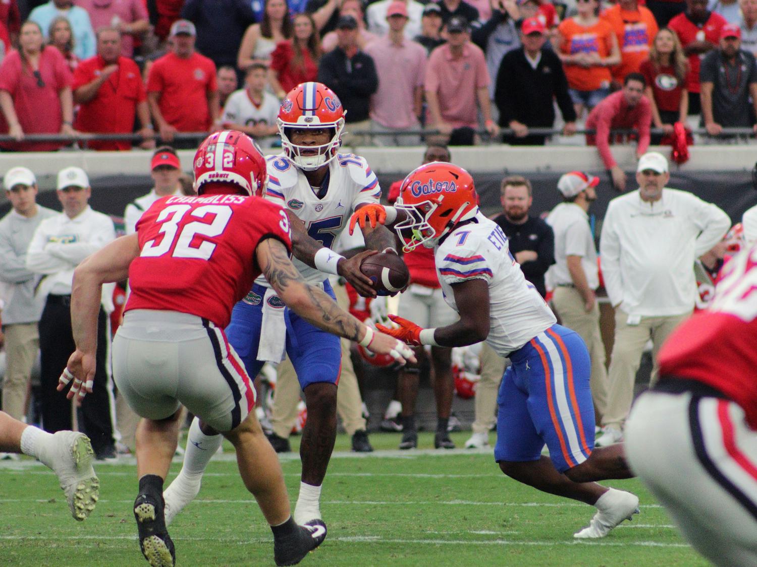 Gators quarterback Anthony Richardson hands off the ball to freshman running back Trevor Etienne during the Florida-Georgia game Saturday, Oct. 29, 2022.