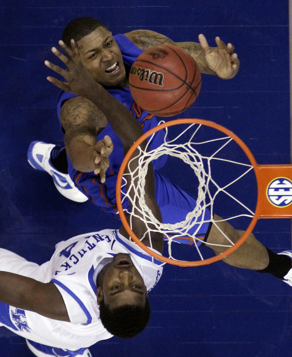 <p>Kentucky forward Michael Kidd-Gilchrist, bottom, and Florida guard Bradley Beal (23) fight for the ball during the second half of Kentucky's 74-71 win. </p>