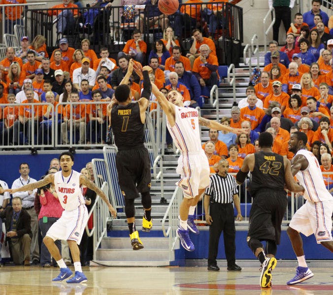 Florida guard Scottie Wilbekin (5) contests a shot by Missouri guard Phil Pressey (1) during the Gators’ 83-52 win against the Tigers on Saturday in the O’Connell Center. UF held Pressey to 1-of-7 shooting with 10 turnovers in the victory.

