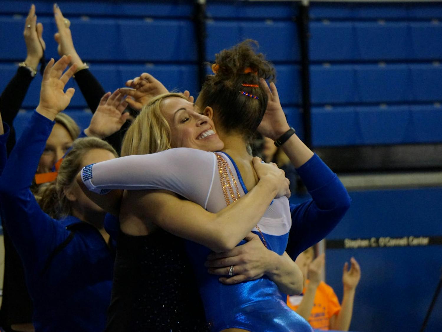 Coach Rhonda Faehn hugs Kytra Hunter following Hunter's balance beam routine during Florida's win against Missouri on Friday in the O'Connell Center.