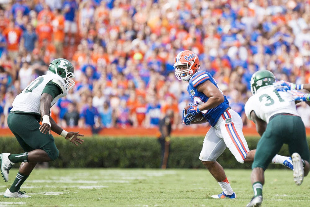 <p>Clay Burton runs with the ball during Florida's 65-0 win against Eastern Michigan on Saturday at Ben Hill Griffin Stadium.</p>