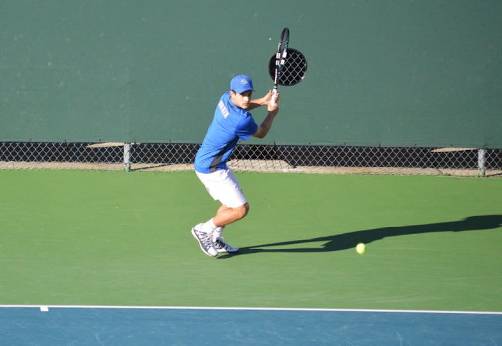 <p>Elliott Orkin attempts to hit the ball during his singles match against&nbsp;UNF on Jan. 22.</p>