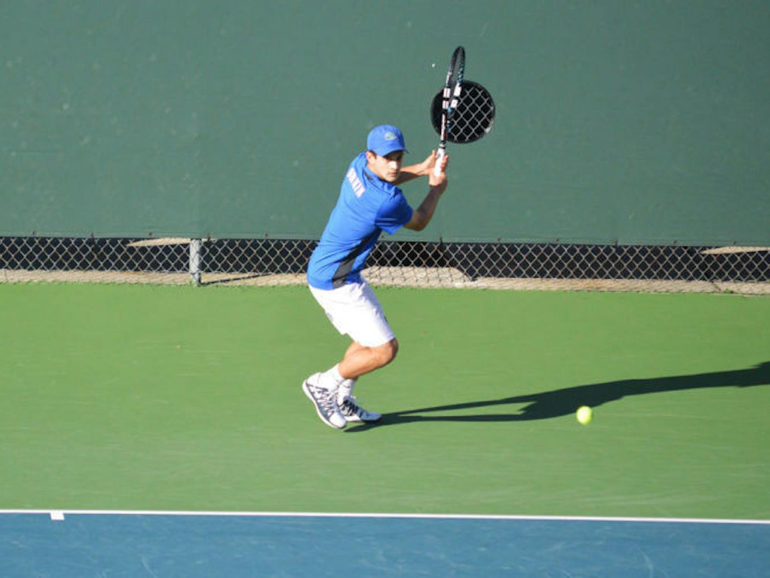 Elliott Orkin attempts to hit the ball during his singles match against UNF on Jan. 22.
