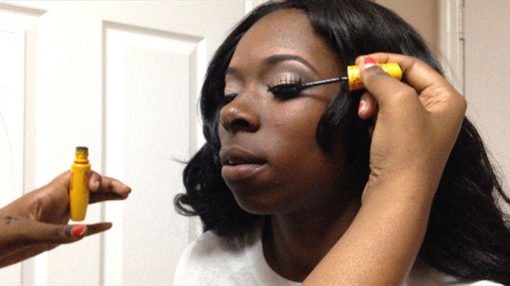 Kenya Tolbert gets her make-up done by 21-year-old advertising junior Stephany Jones. Tolbert won a complete makeover for her senior prom at Eastside High School.