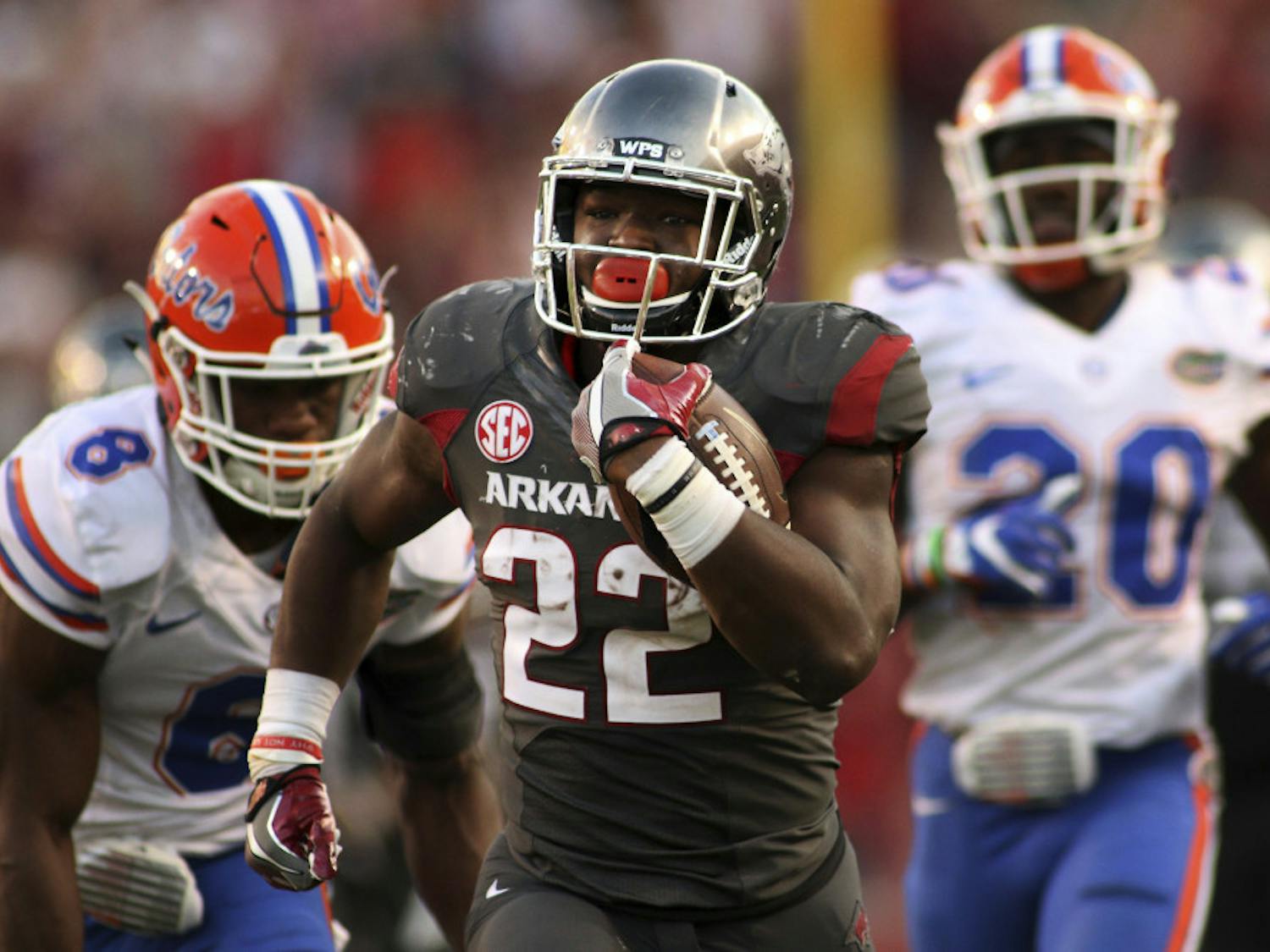 Arkansas' Rawleigh Williams III (22) outruns Florida's Nick Washington (8) and DeAndre Goolsby (30) during the second half of an NCAA college football game Saturday, Nov. 5, 2016 in Fayetteville, Ark. Arkansas beat Florida 31-10. (AP Photo/Samantha Baker)