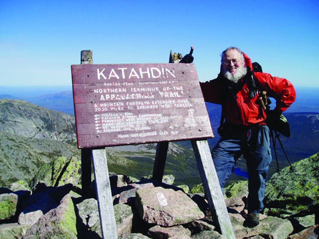 Dr. Bill Luttge poses at the northern end of the Appalachian Trail on the top of Mount Katahdin in Baxter State Park in Millinocket, Maine in 2004.