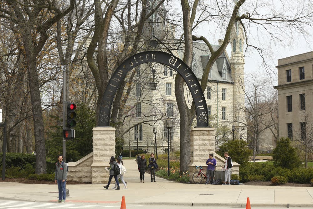 <p>In this Friday, April 29, 2016, photo, people stand near the entrance gate to Northwestern University in Evanston, Ill. Northwestern University's student newspaper is under fire. Their first critics came from within the campus as student activists questioned journalists’ coverage of protests. Within days, editors decided to write a statement apologizing but their editorial prompted a second round of criticism from journalists around the country starting Monday, Nov. 11, 2019. (Chris Walker/Chicago Tribune via AP)</p>