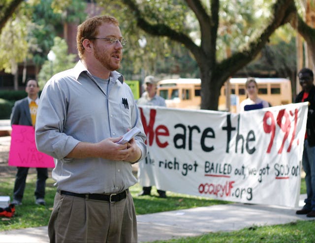 Joe Richard, 24, speaks to the occupy UF supporters and onlookers in the Plaza of the Americas on Wednesday.