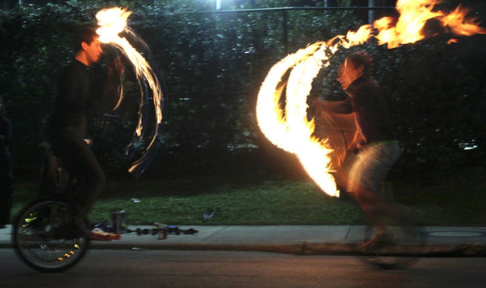 <p>UF graduate student in the Digital Worlds Institute Ian Elsner, 23, left, and electrical engineering junior Matt Feldman, 20, juggle fire outside the Broward Hall basement Thursday Night. Read the story at alligator.org.</p>