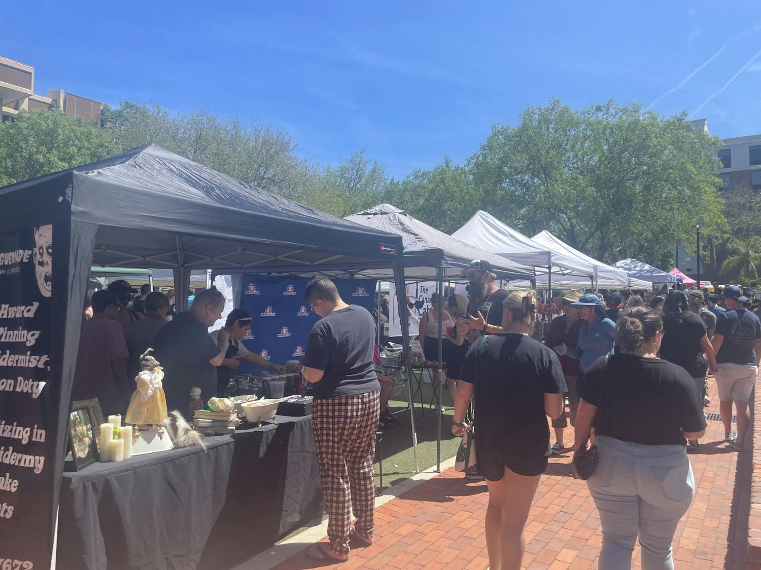 Visitors to the Gainesville Oddities Market explore the unusual items sold at the booths on April 7, 2023.