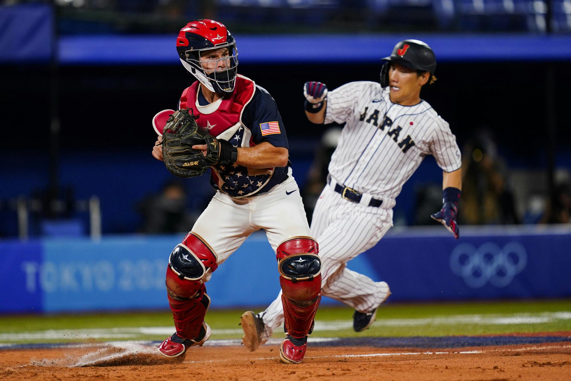 United States catcher Mark Kolozsvary forces out Japan's Masataka Yoshida on a fielder's choice by Japan's Yuki Yanagita during the gold medal baseball game at the 2020 Summer Olympics, Saturday, Aug. 7, 2021, in Yokohama, Japan. (AP Photo/Matt Slocum)