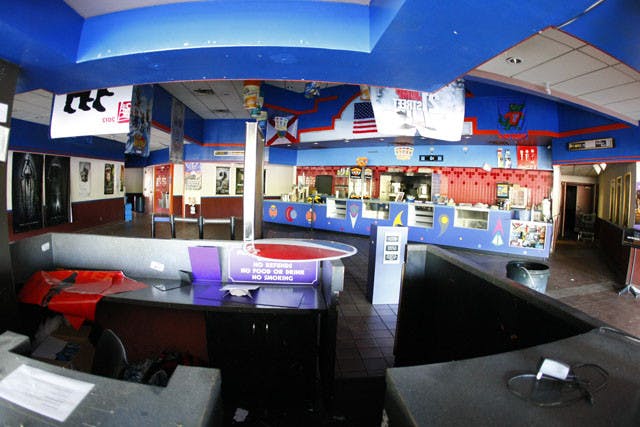 Gator Cinemas, located off West Newberry Road next to the Oaks Mall, remains closed as dust and cobwebs build up inside.