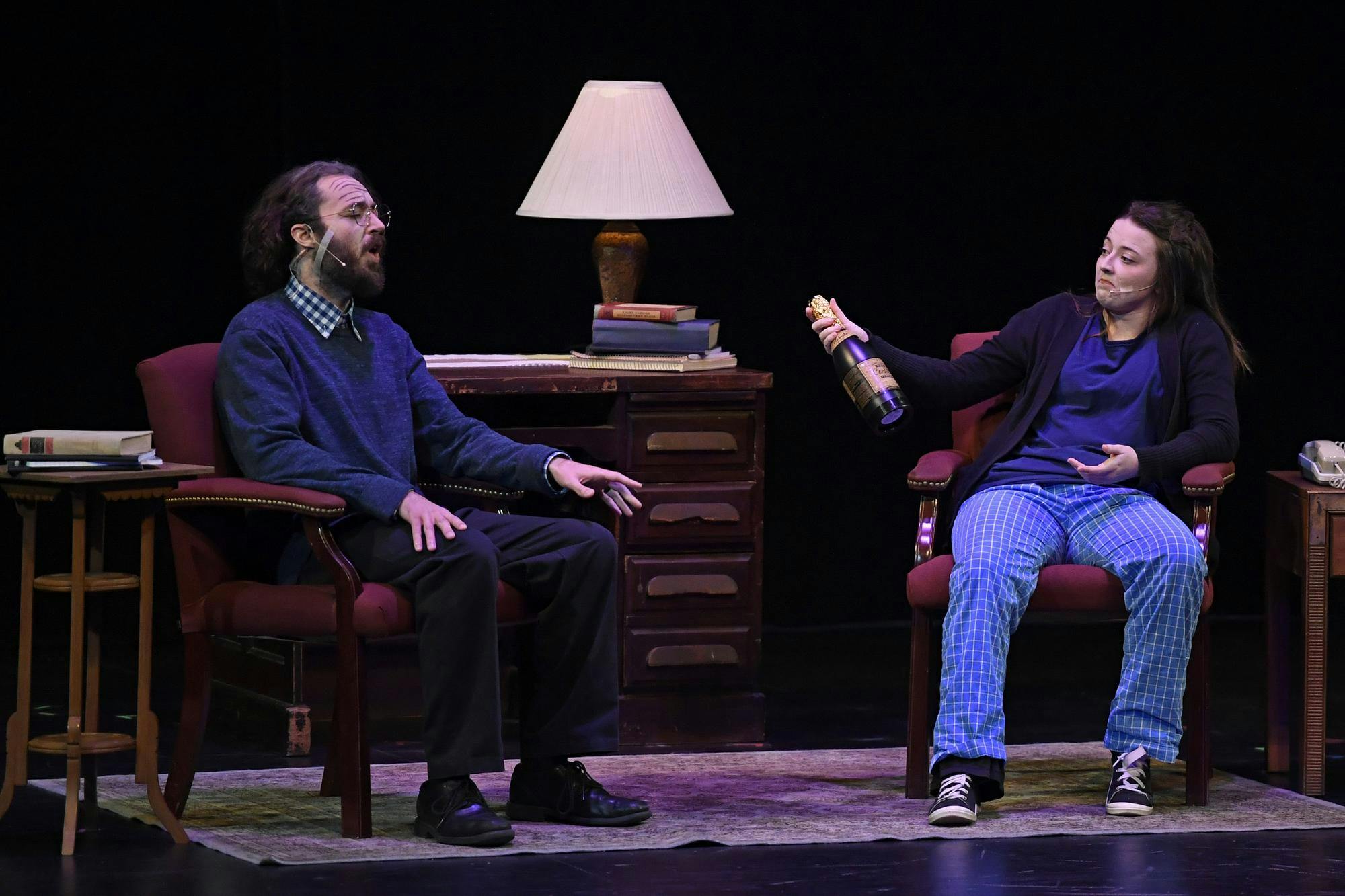 An actress offers an actor a bottle of champagne as a “ten-minute play” is performed on Friday, Jan. 30, 2026, at the Jackson N. Sasser Fine Arts Hall at Santa Fe College in Gainesville, Fla.