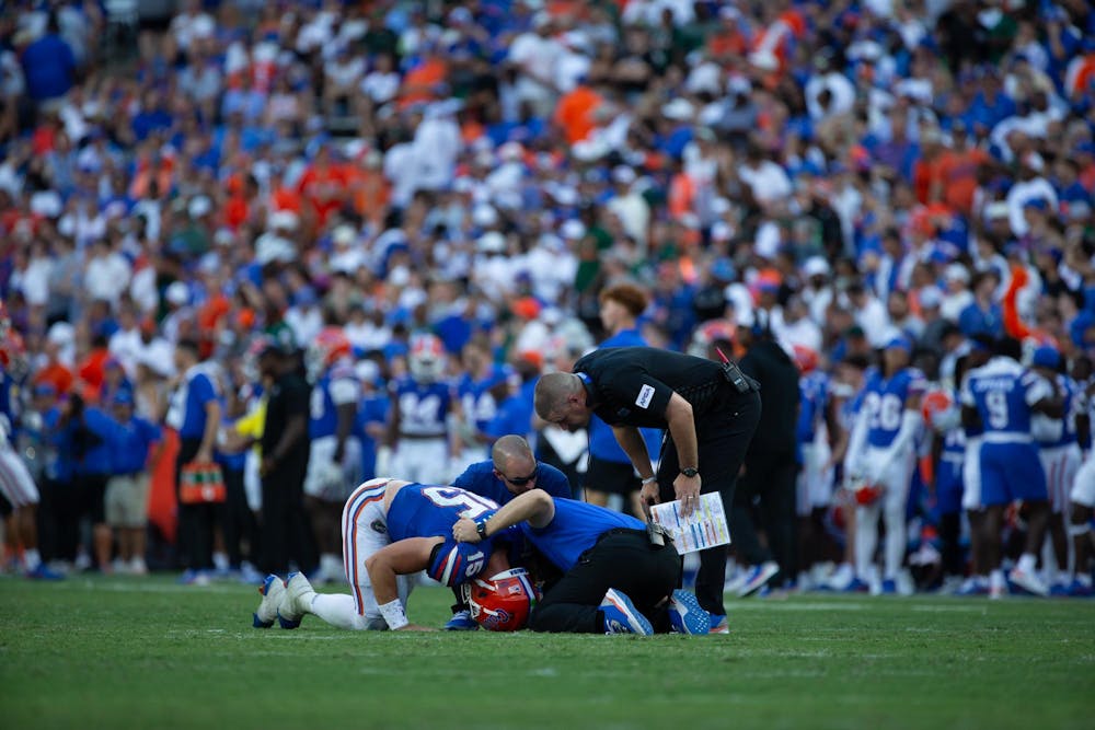 Florida quarterback Graham Mertz kneels down on the field after being injured during the third quarter of the Gator's game vs the Miami Hurricanes on Saturday, Aug, 31.