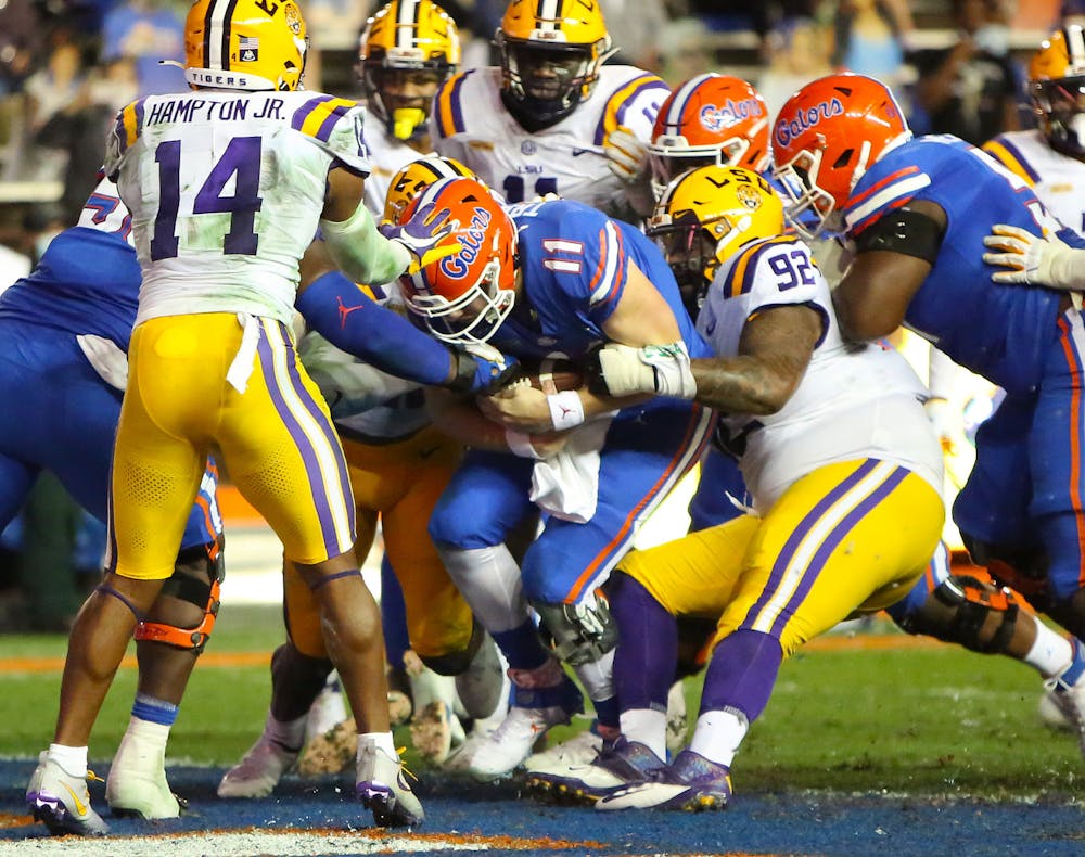 Gators quarterbacks Kyle Trask (11) runs the ball in for the Gators' first touchdown against LSU Saturday night. [Brad McClenny/The Gainesville Sun]   