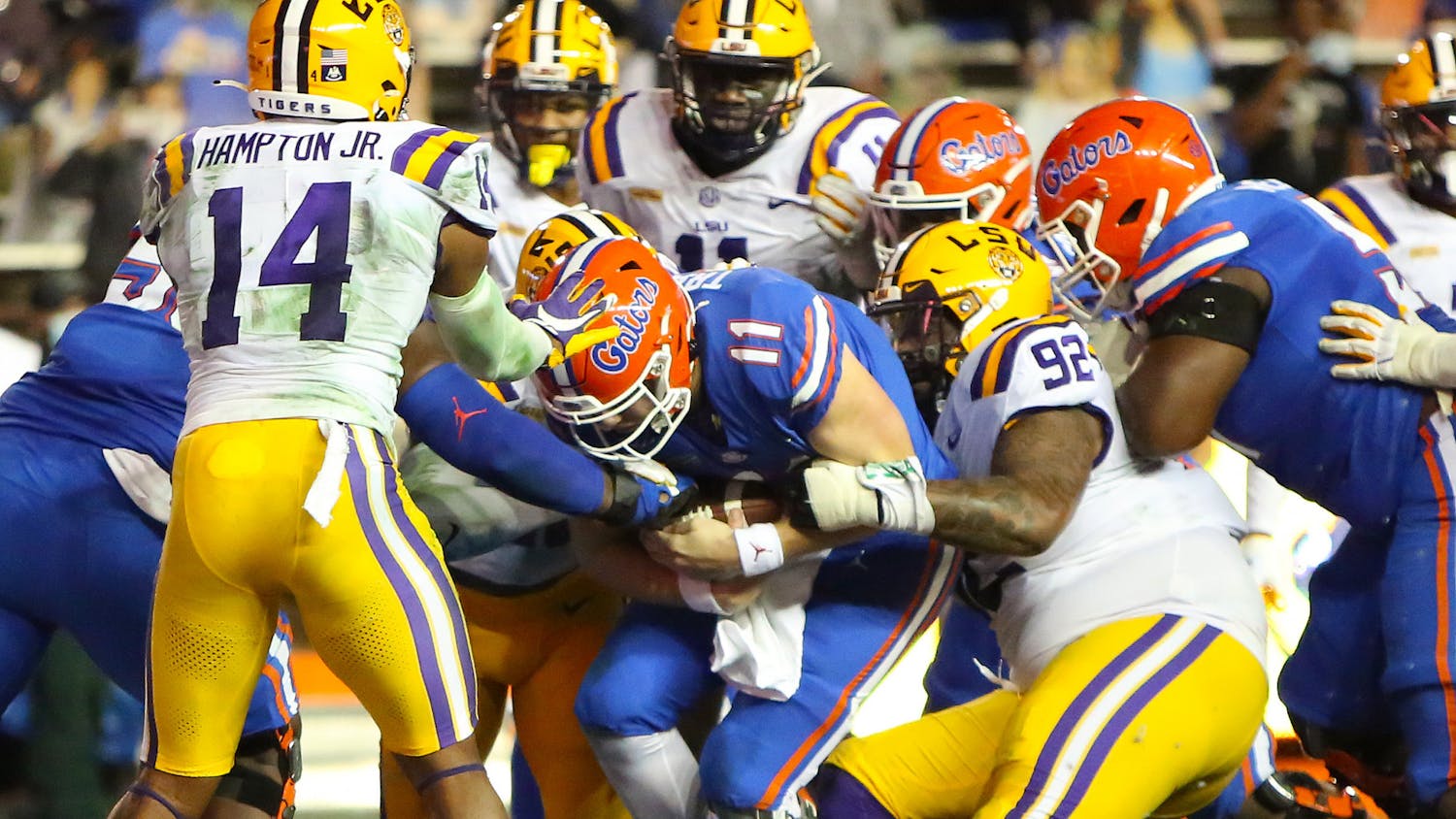 Gators quarterbacks Kyle Trask (11) runs the ball in for the Gators' first touchdown against LSU Saturday night. [Brad McClenny/The Gainesville Sun]   