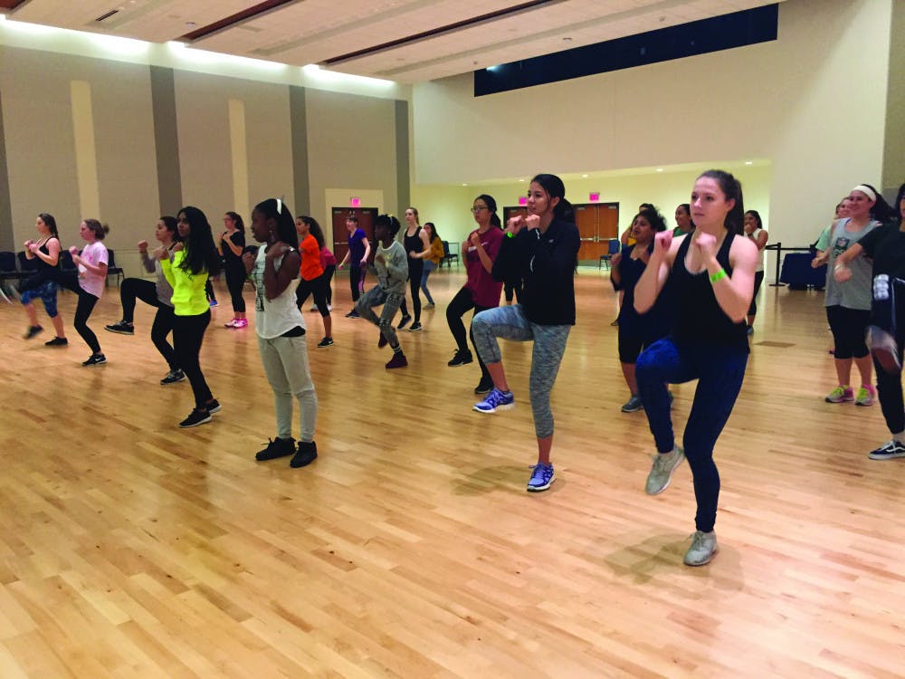 <p><span id="docs-internal-guid-3eee32e7-8b9a-7420-dc97-611fbda52736"><span>Students warm up for kickboxing in the Rion Ballroom. Thirty-three students attended the event held by Reitz Union Board Entertainment.</span></span></p>