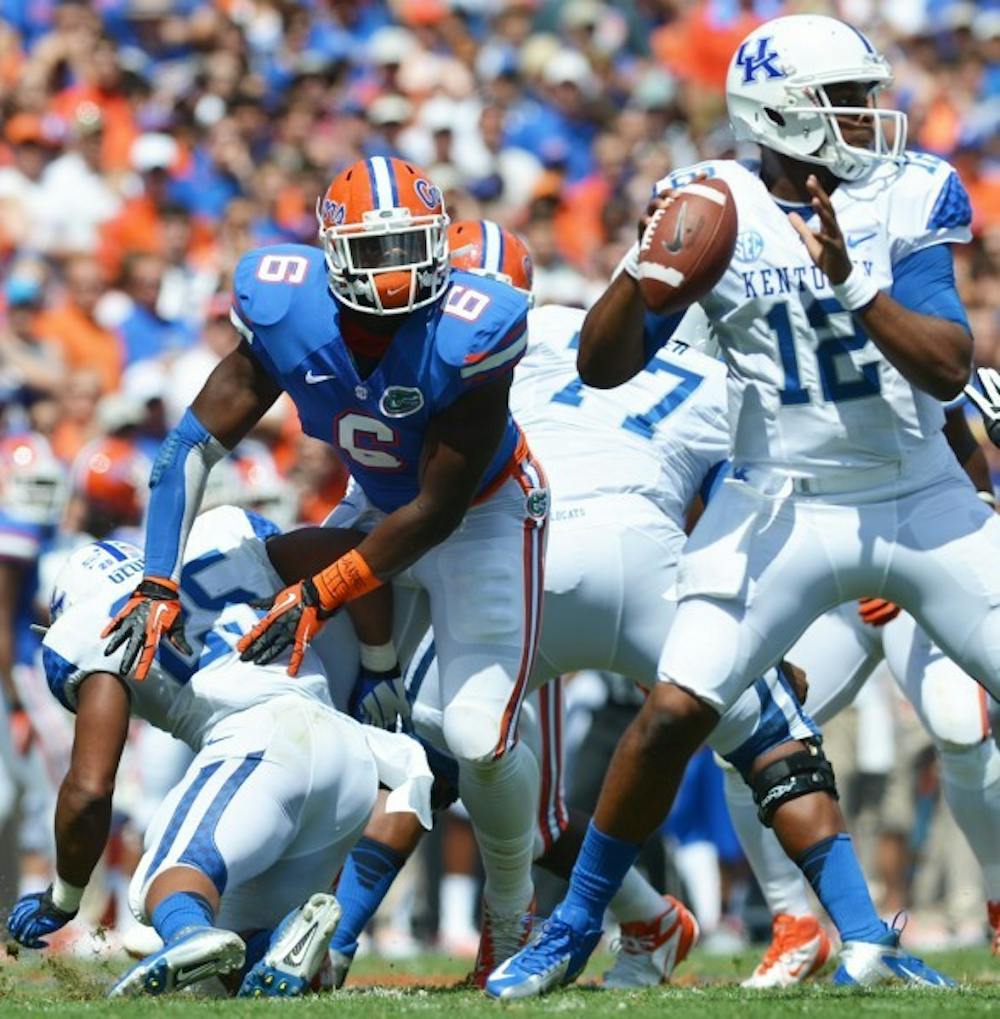 <p>Dante Fowler Jr. (6) pursues Kentucky’s Morgan Newton (12) in UF’s 38-0 win on Sept. 22 in Ben Hill Griffin Stadium. Fowler followed up a strong Thursday practice with another impressive performance Saturday during UF's open practice at The Swamp.&nbsp;</p>