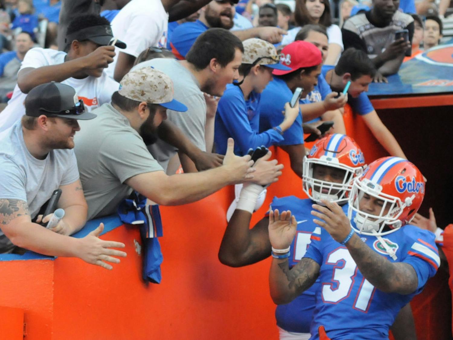 Cornerback Jalen Tabor high fives fans while walking out of the tunnel prior to the Orange &amp; Blue Debut on April 8, 2016, at Ben Hill Griffin Stadium.