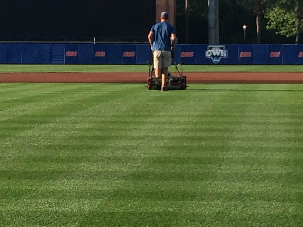 <p>Kaleb Lewis mows the infield at McKethan Stadium on Monday, April 17, 2017.</p>