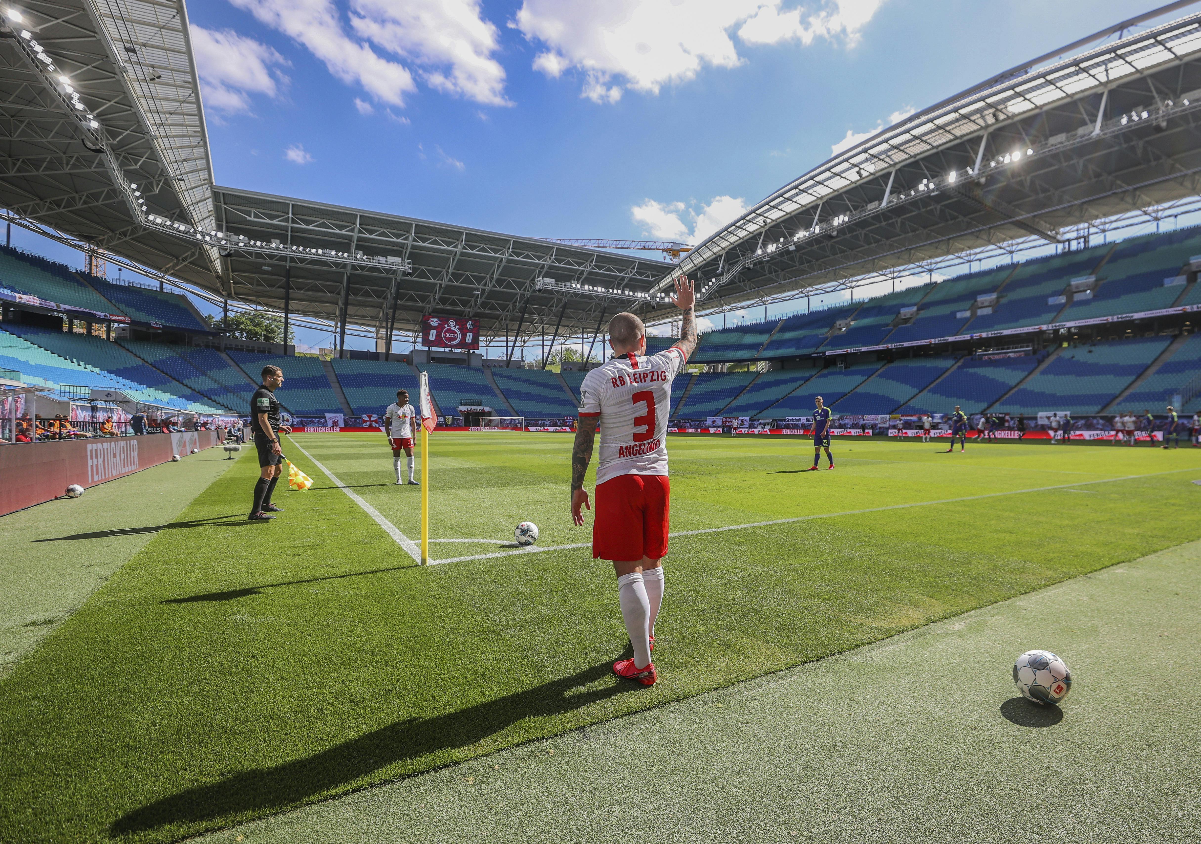 Leipzig's Angelino gestures before taking a corner during the German Bundesliga soccer match between RB Leipzig and SC Freiburg in Leipzig, Germany, Saturday, May 16, 2020. The German Bundesliga becomes the world's first major soccer league to resume after a two-month suspension because of the coronavirus pandemic. (Jan Woitas/dpa via AP)