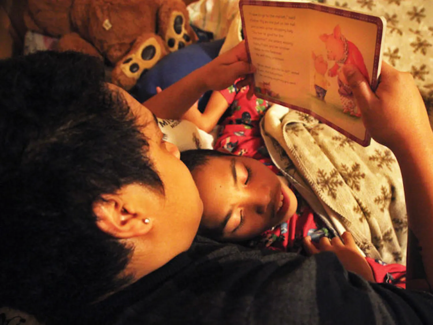 Joel Ratovoson reads a bedtime story to Daniel Ratovoson on Nov. 27.