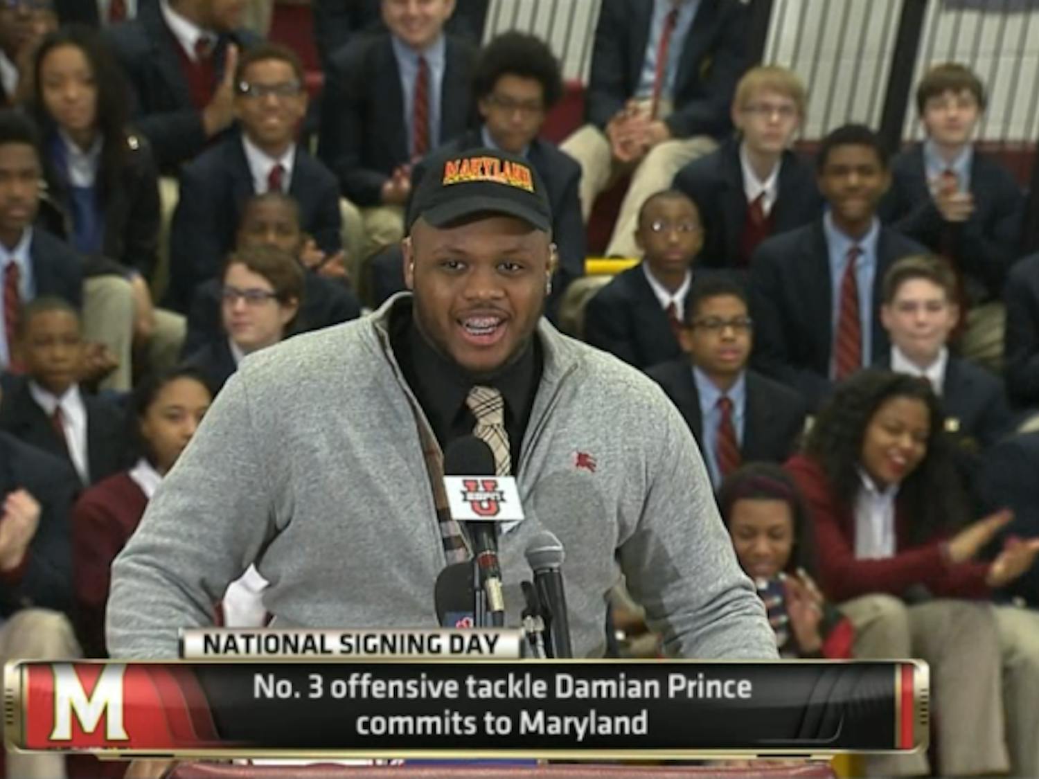 Five-star offensive tackle Damian Prince announces his commitment to Maryland at Bishop McNamara High School on Wednesday morning.