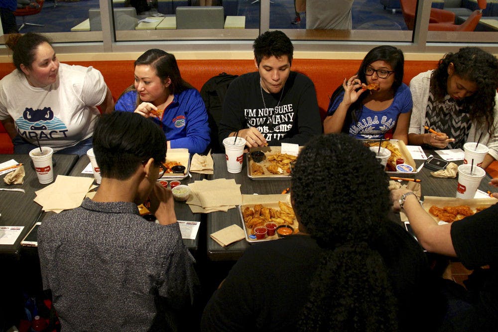 <p>Specially selected students, who were chosen as part of a test group to help Wing Zone employees train for their first day open on Friday at 4 p.m., eat wings and fries at the new Union location Tuesday. About fifty people were chosen for each test group, of which there were four on Tuesday and will be more on Wednesday.</p>