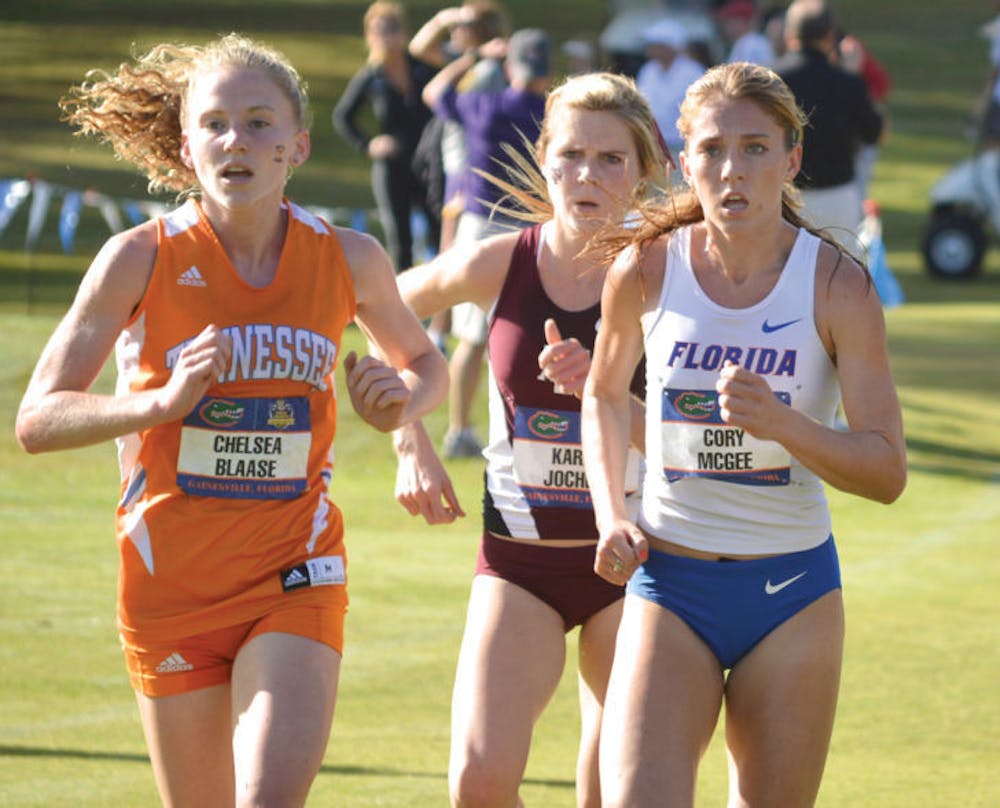 <p>Cory McGee (right) runs at the Southeastern Conference Cross Country Championships at the Mark Bostick Golf Course on Nov. 23, 2013. She won the 800-meter run at the UAB Invite.</p>