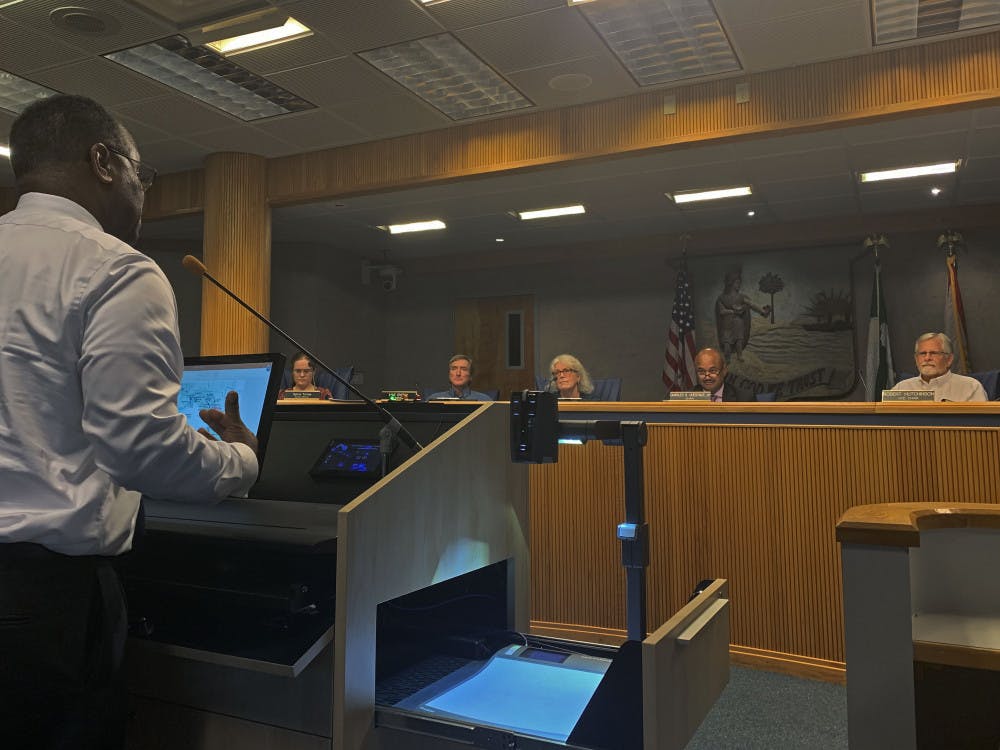 <p dir="ltr">James McKnight, a 62-year-old Gainesville resident, speaks to county commissioners during public comment at a meeting on Tuesday evening. McKnight and his neighbors spoke about the lack of road maintenance at NE 27th Avenue in Northeast Gainesville. </p>