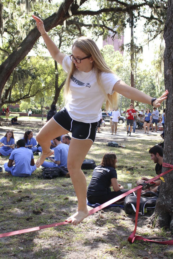 Kayla Bock, a 19-year-old UF elementary education sophomore, slacklines on the Plaza of the Americas on Oct. 16, 2015.