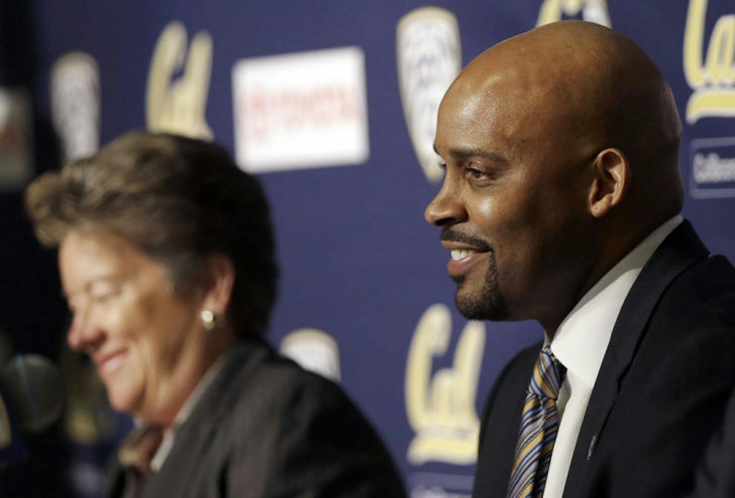 Former Tennessee men’s basketball coach Cuonzo Martin (right) smiles as he is introduced as Cal’s new coach at a press conference Tuesday in Berkeley, Calif.