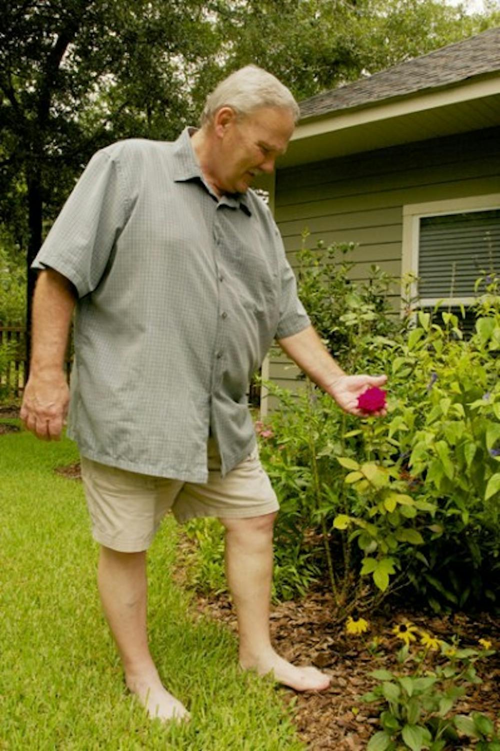 <p>UF professor of entomology and nematology Carl Barfield relaxes in his backyard after a day of gardening Monday afternoon. Barfield will be retiring after 35 years of teaching.</p>
