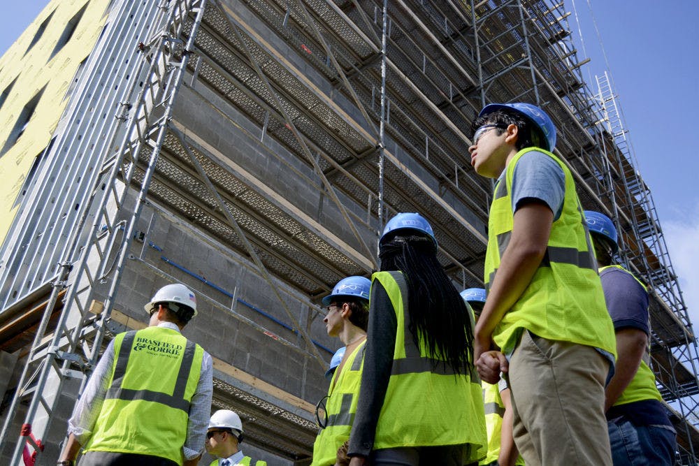<p>Sean Parker (right), a 20-year-old UF economics sophomore, joins the rest of a tour group viewing the Infinity Hall construction site Tuesday afternoon. A student enrolled in the Innovation Academy, Parker said he was interested in the possibility of living in Infinity Hall next fall.</p>