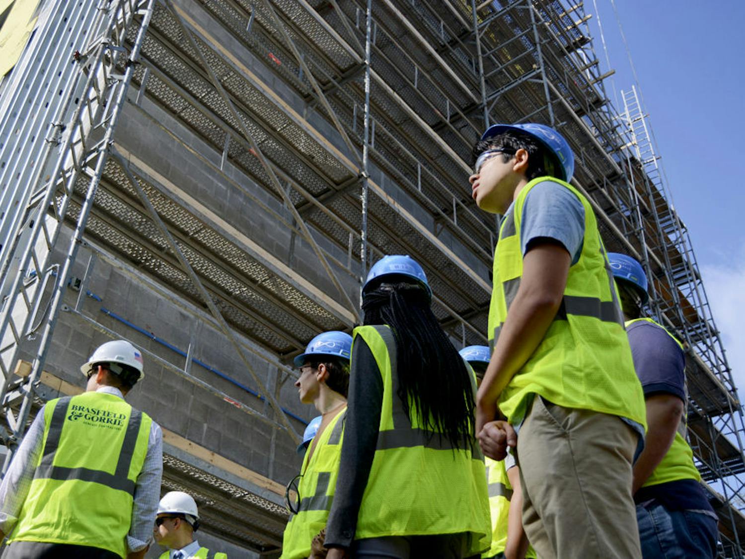 Sean Parker (right), a 20-year-old UF economics sophomore, joins the rest of a tour group viewing the Infinity Hall construction site Tuesday afternoon. A student enrolled in the Innovation Academy, Parker said he was interested in the possibility of living in Infinity Hall next fall.