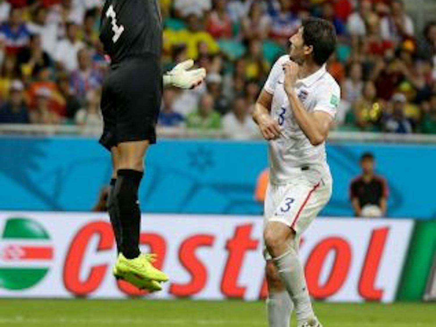 United States’ goalkeeper Tim Howard leaps over Omar Gonzalez to tip the ball away during the U.S.’ 2-1 loss to Belgium on Tuesday.