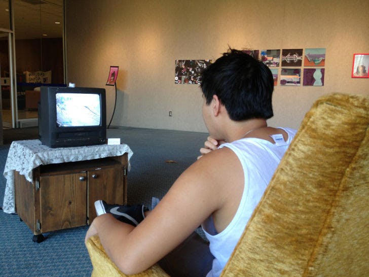 Bac Cheng Huang, a 21-year-old industrial and systems engineering major, watches a bizarre addition to the Reclamation! art gallery.