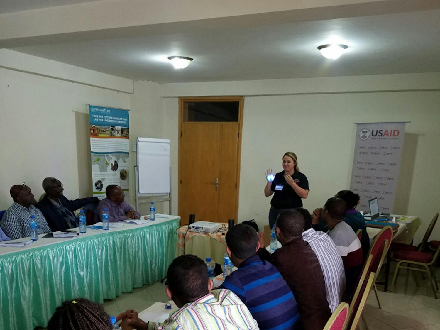Taylor Langford teaches participants in Ethiopia how to properly wash their hands and how easily germs can spread using Glo Germ and a blacklight.