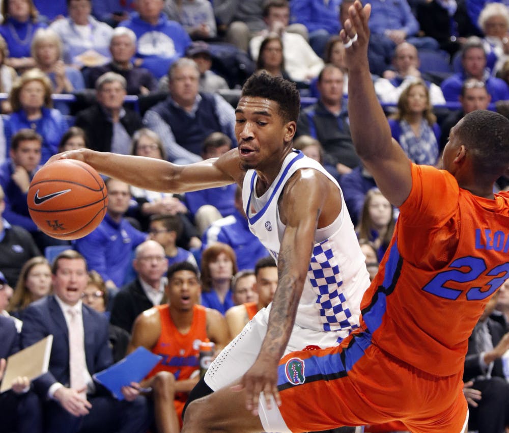 Kentucky's Malik Monk, left, looks for an opening on Florida's Justin Leon during the first half of an NCAA college basketball game, Saturday, Feb. 25, 2017, in Lexington, Ky. (AP Photo/James Crisp)