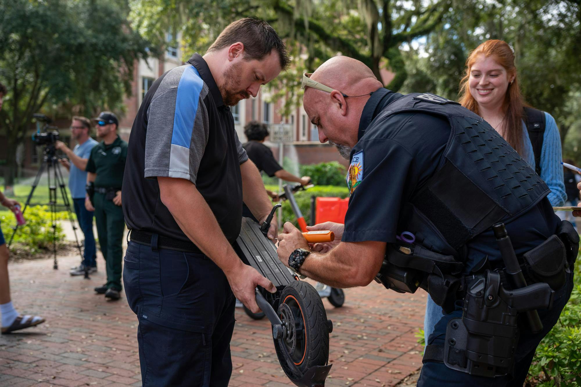 Officer Nate Smith engraves an e-scooter for a UF student at the Newell Gateway, Monday, Aug. 31, 2026, in Gainesville, Fla.