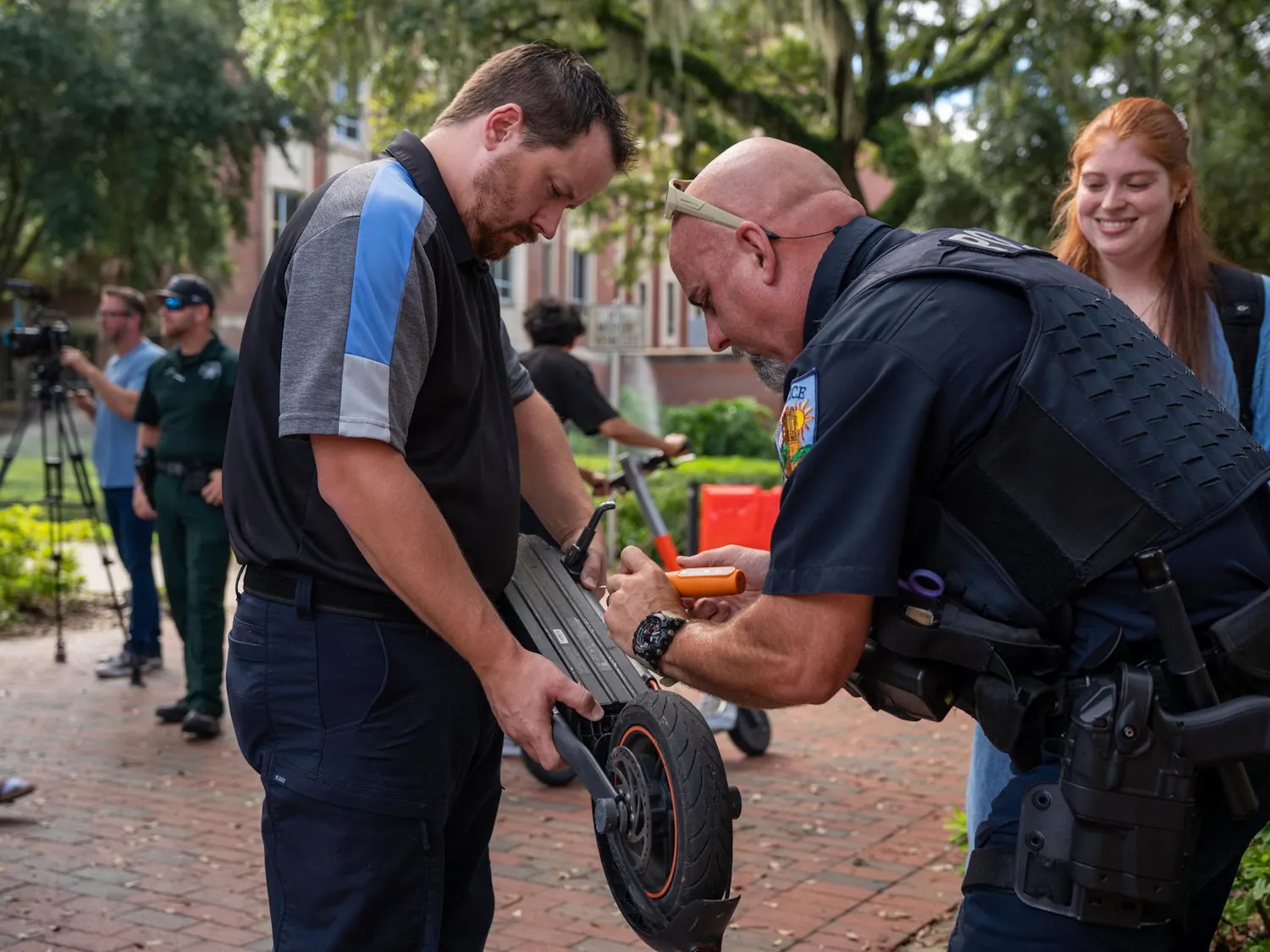 Officer Nate Smith engraves an e-scooter for a UF student at the Newell Gateway, Monday, Aug. 31, 2026, in Gainesville, Fla.
