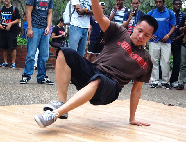 Santa Fe business administration junior Tu Le, 21, break dances on Turlington Plaza on Wednesday to promote Passion Through the Noise talent showcase. The showcase will be on Saturday from 6 to 9 p.m. at the Gator Wesley Foundation, located at 1380 W. University Ave. General admission is $10 and proceeds go to Project P-Noise to support underprivileged Bboys in the Philippines.