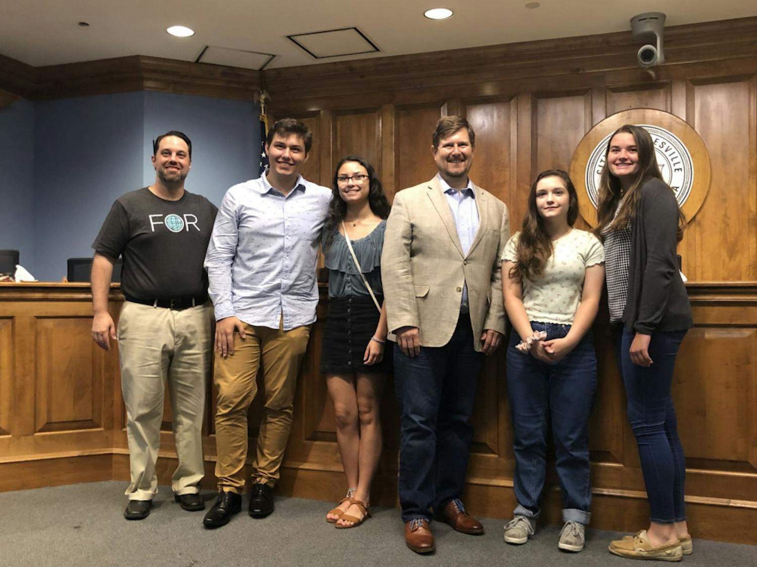 (Left to Right) Joshua Forgione, Matt Mann, Bella Wilson, Mayor Lauren Poe, Keelyn Fife and Alissa Humphrey pose for a photo after presenting their projects in the City Commission room.&nbsp;