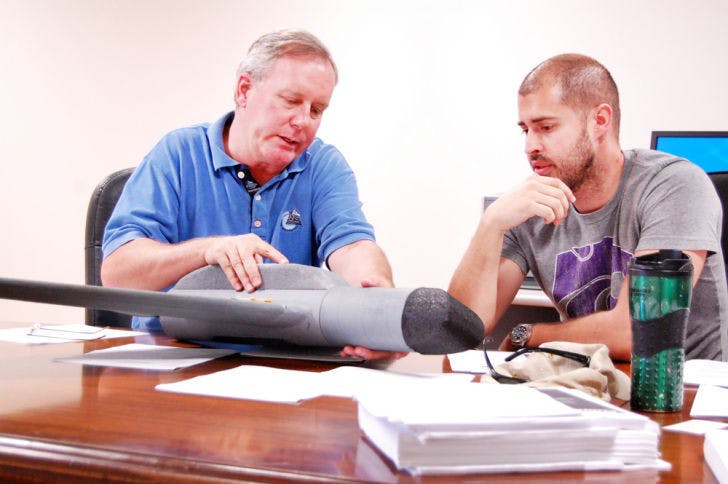 Program managers Patrick Seidel, 53, left, and John Morgan, 32, discuss plans about aircraft Four Delta on Saturday at the Power District Catalyst Building east of Kelly Power Plant.