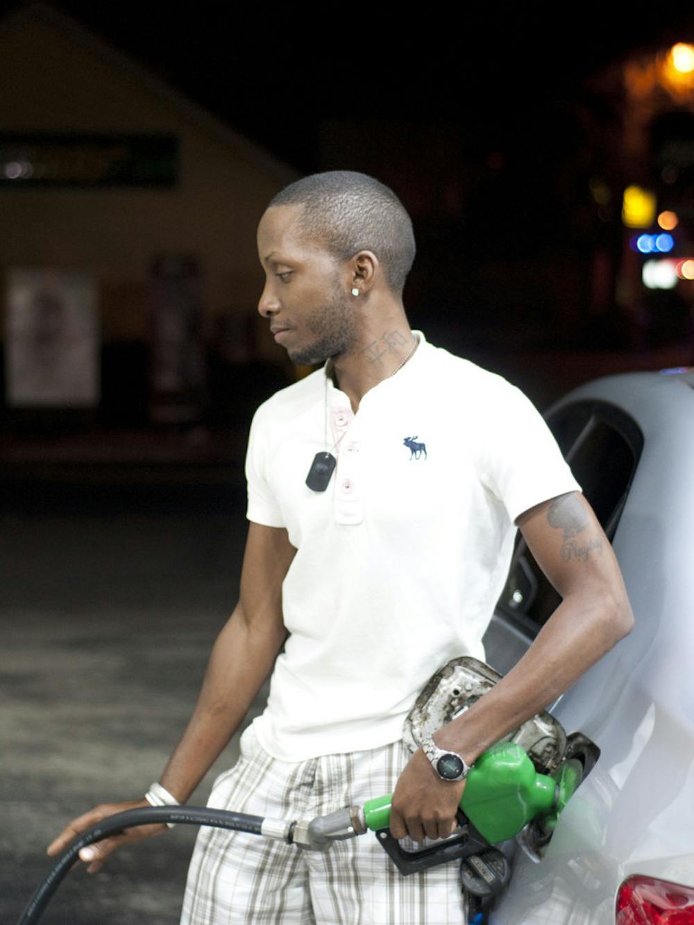 <p>Business administration junior Ricky Harris, 27, fills his tank at the BP gas station at 931 W. University Ave. on Wednesday afternoon. The average price for one gallon of regular gas in Gainesville is $3.35.</p>