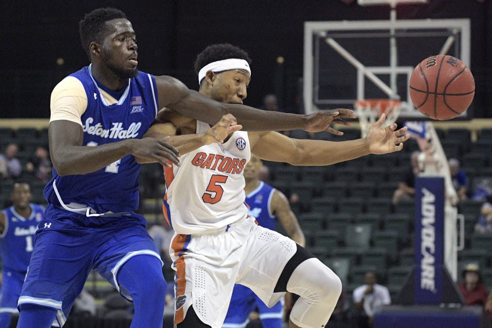 Seton Hall forward Ismael Sanogo, left, and Florida guard KeVaughn Allen (5) reach for the ball during the second half of an NCAA college basketball game in Lake Buena Vista, Fla., Thursday, Nov. 24, 2016. Florida won 81-76. (AP Photo/Phelan M. Ebenhack)