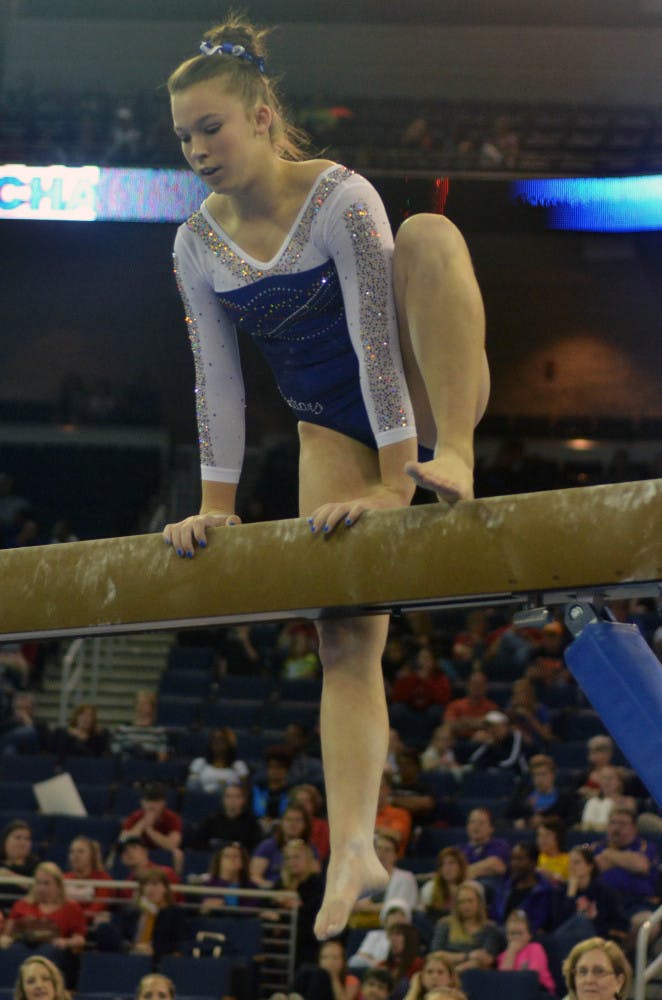 Freshman Ericha Fassbender steps back onto the balance beam after falling during the Southeastern Conference Championships on March 21 in Duluth, Georgia.