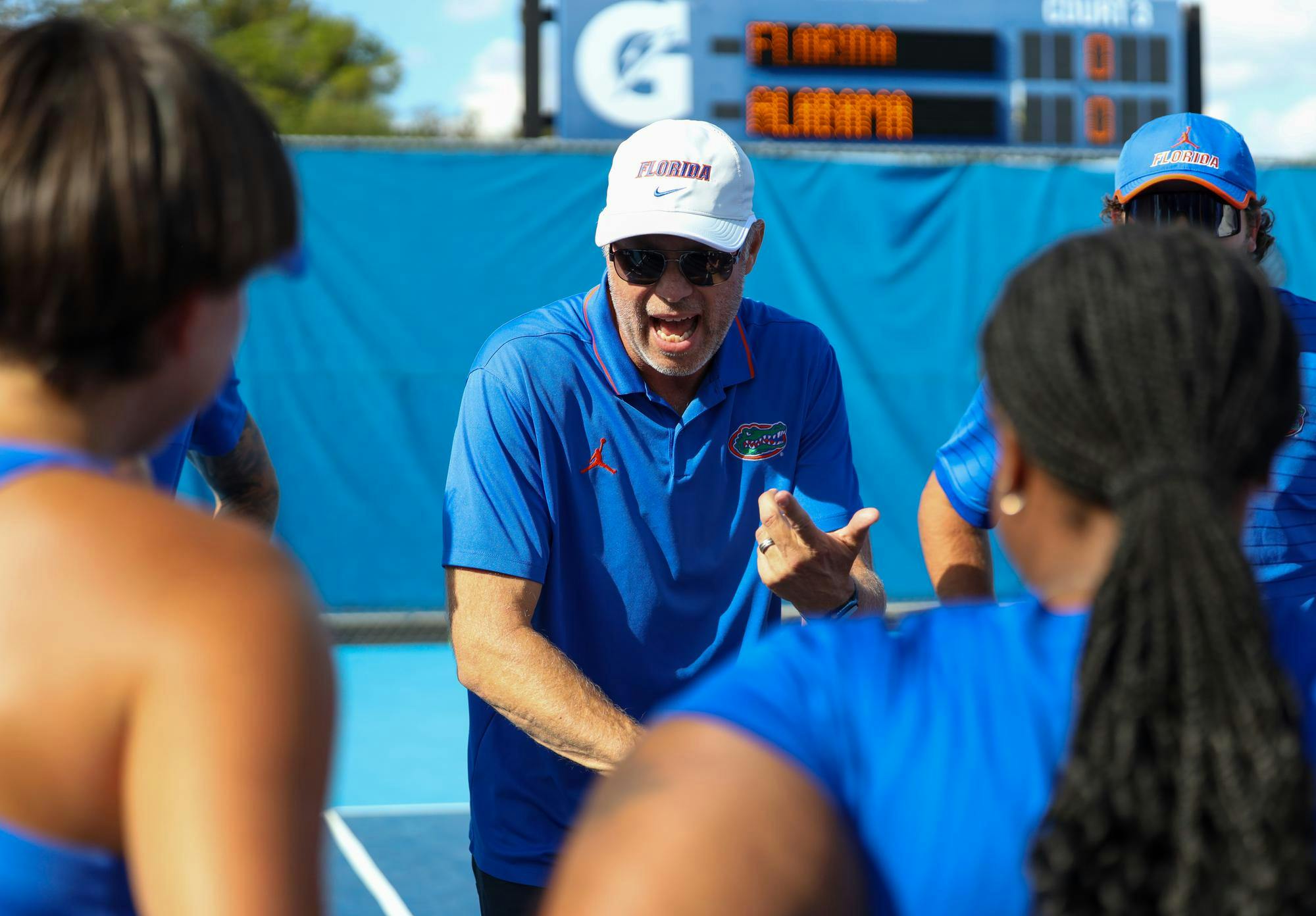 UF women's tennis head coach, Per Nilsson, speaks to his team in a huddle before their matchup against Alabama on Thursday, March 26, 2026 in Gainesville, Fla.
