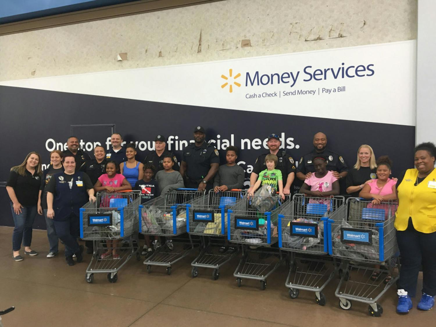All of the GPD School Resource Officers with the children and their purchased items.