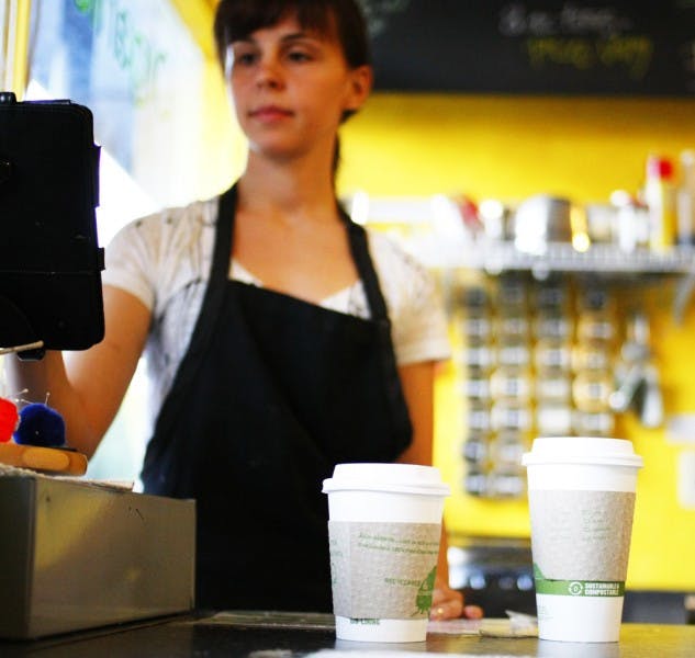 Emily Schwartz, 25, serves coffee at Karma Cream on West University Avenue. A new study published in the New England Journal of Medicine linked drinking coffee to living longer.